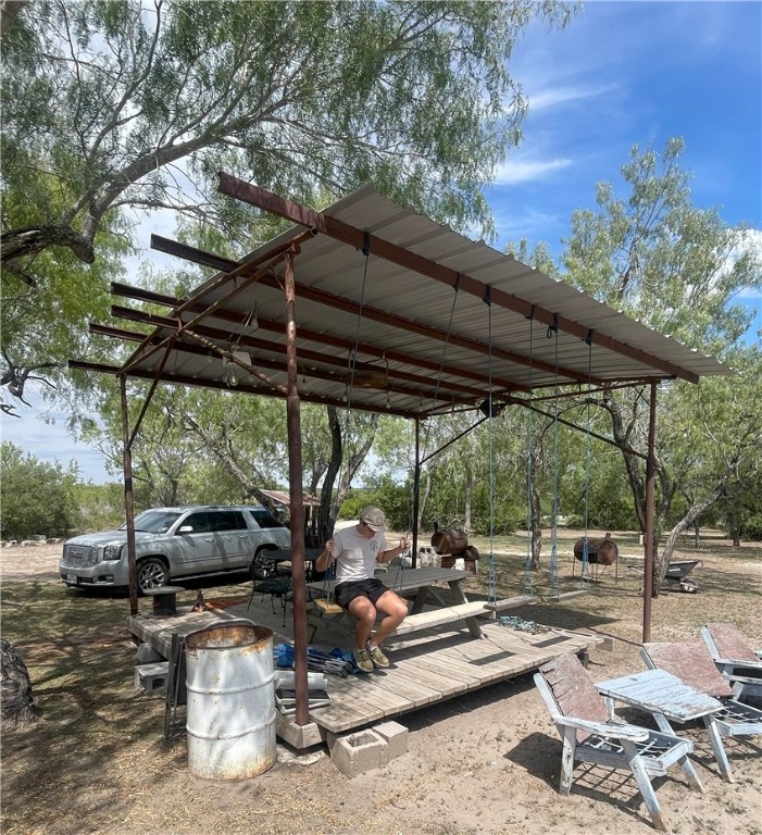 211 County Road 229 Three Rivers, TX 78071 - Photo 16 of 18 a view of backyard with outdoor seating and plants