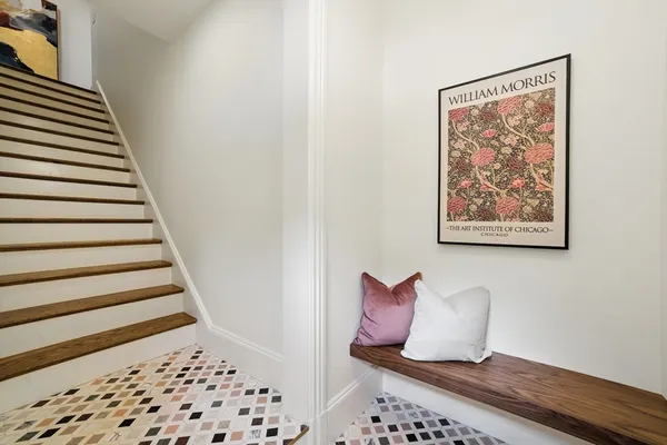 a view of a hallway with wooden floor and chair