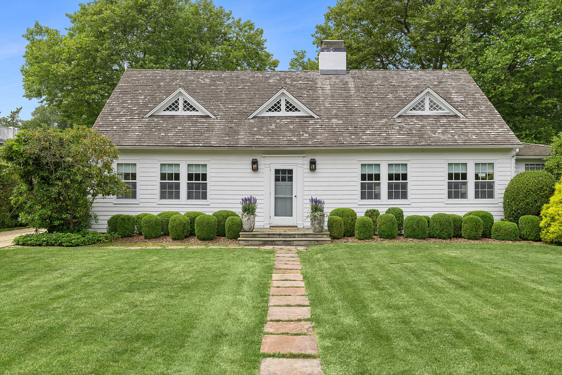 93 Egypt Lane East Hampton, NY 11937 - Photo 2 of 50 a front view of house with yard and green space
