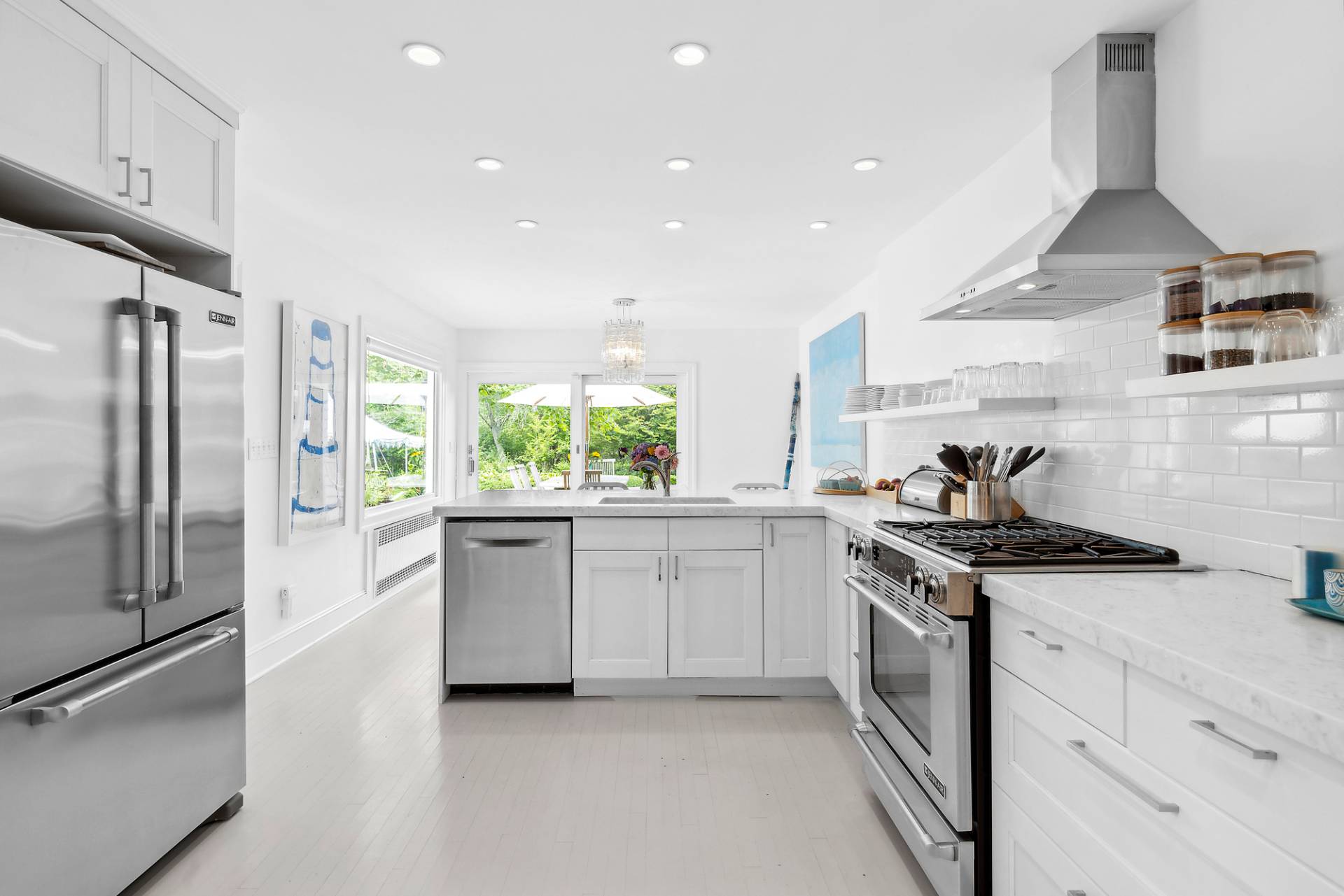 93 Egypt Lane East Hampton, NY 11937 - Photo 21 of 50 a kitchen with stainless steel appliances granite countertop a sink and a refrigerator
