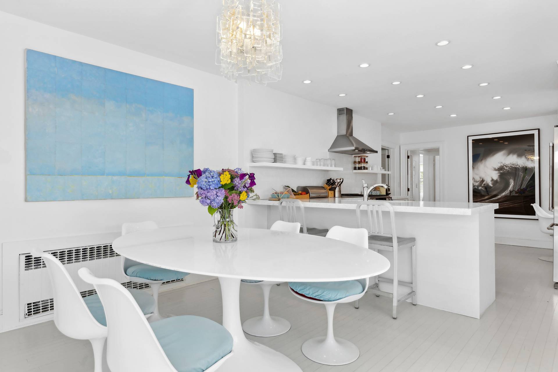 93 Egypt Lane East Hampton, NY 11937 - Photo 25 of 50 a kitchen with stainless steel appliances kitchen island granite countertop a dining table chairs and white cabinets