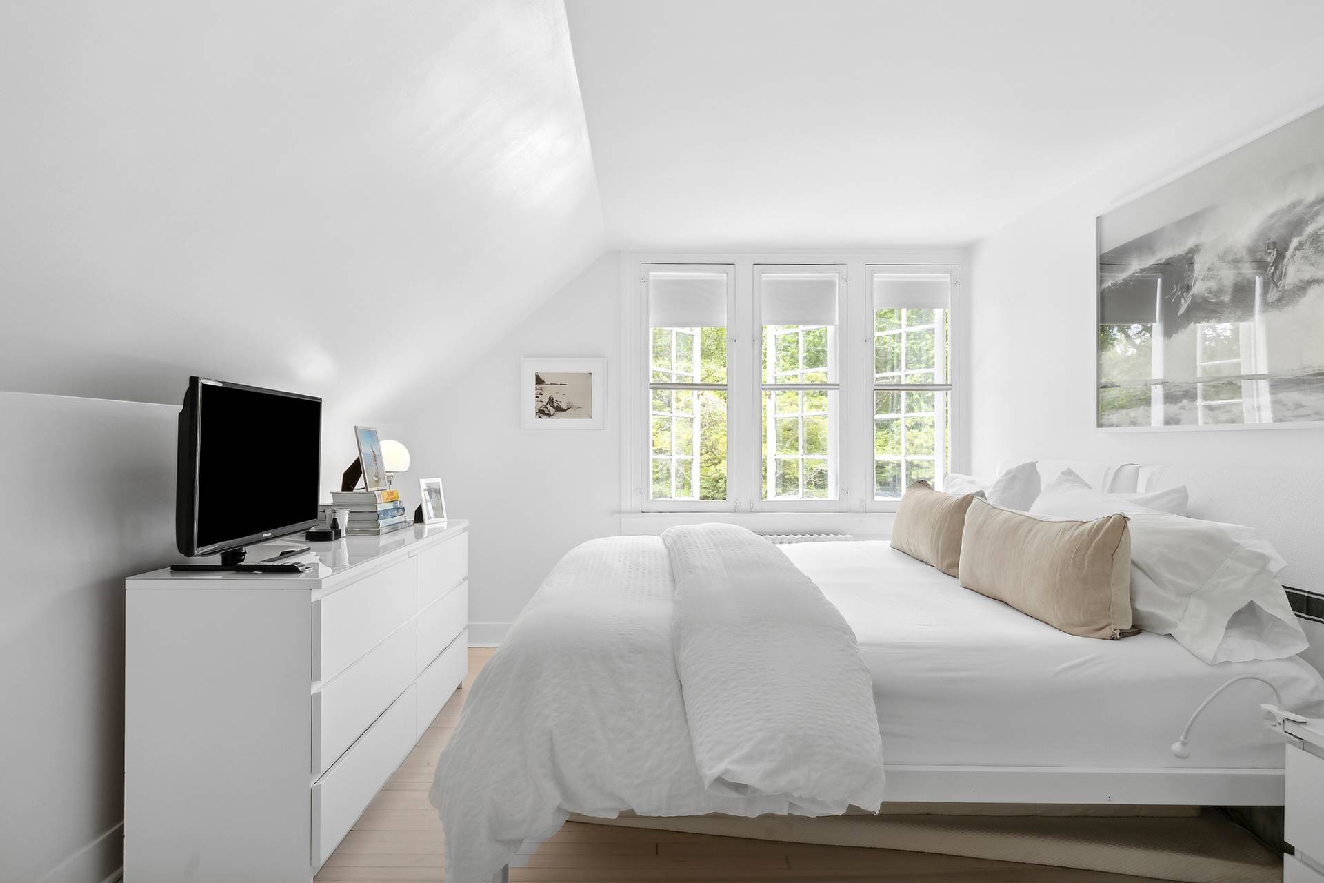 93 Egypt Lane East Hampton, NY 11937 - Photo 37 of 50 a bedroom with a bed and a flat screen tv