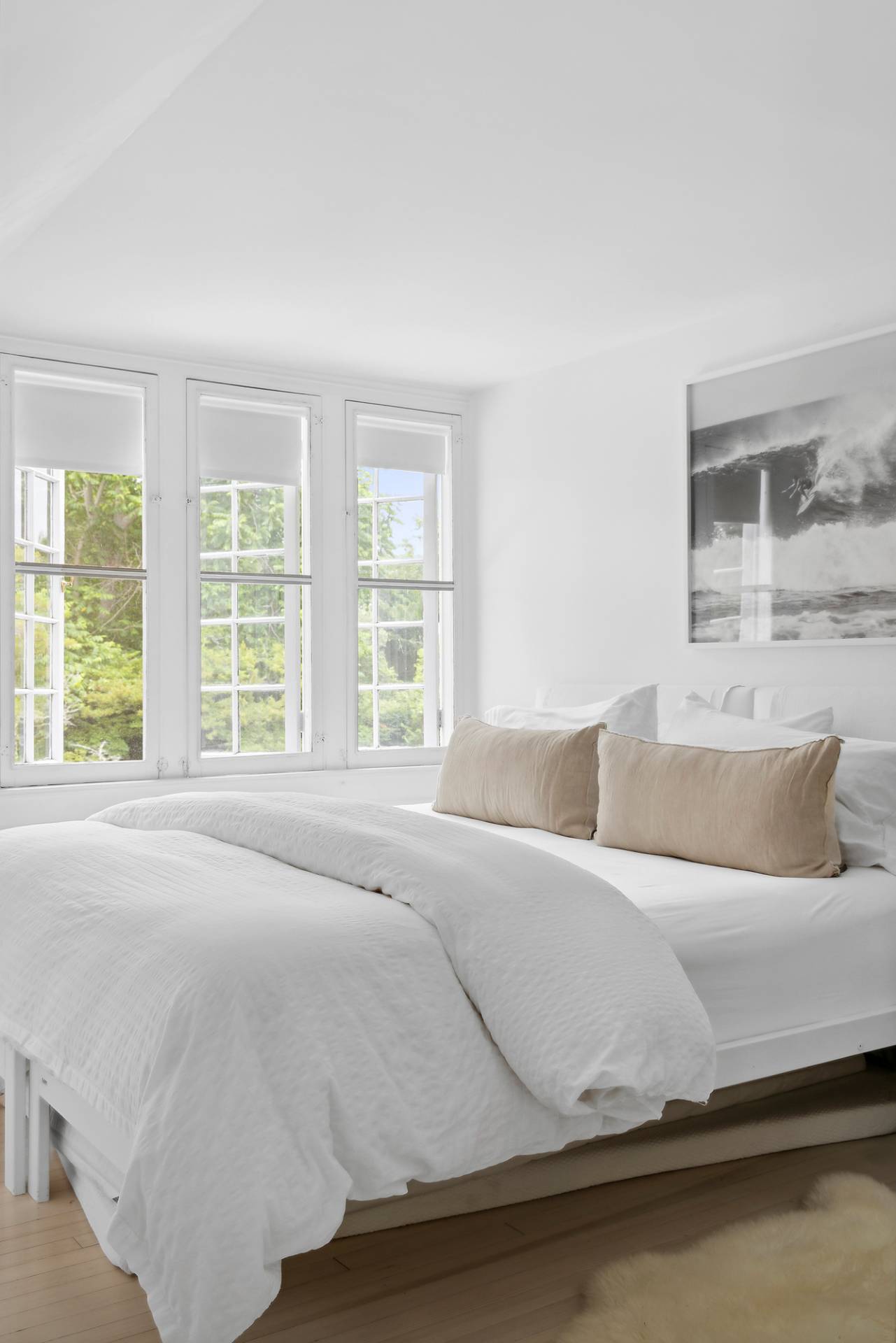 93 Egypt Lane East Hampton, NY 11937 - Photo 43 of 50 a bedroom with a bed and two large window