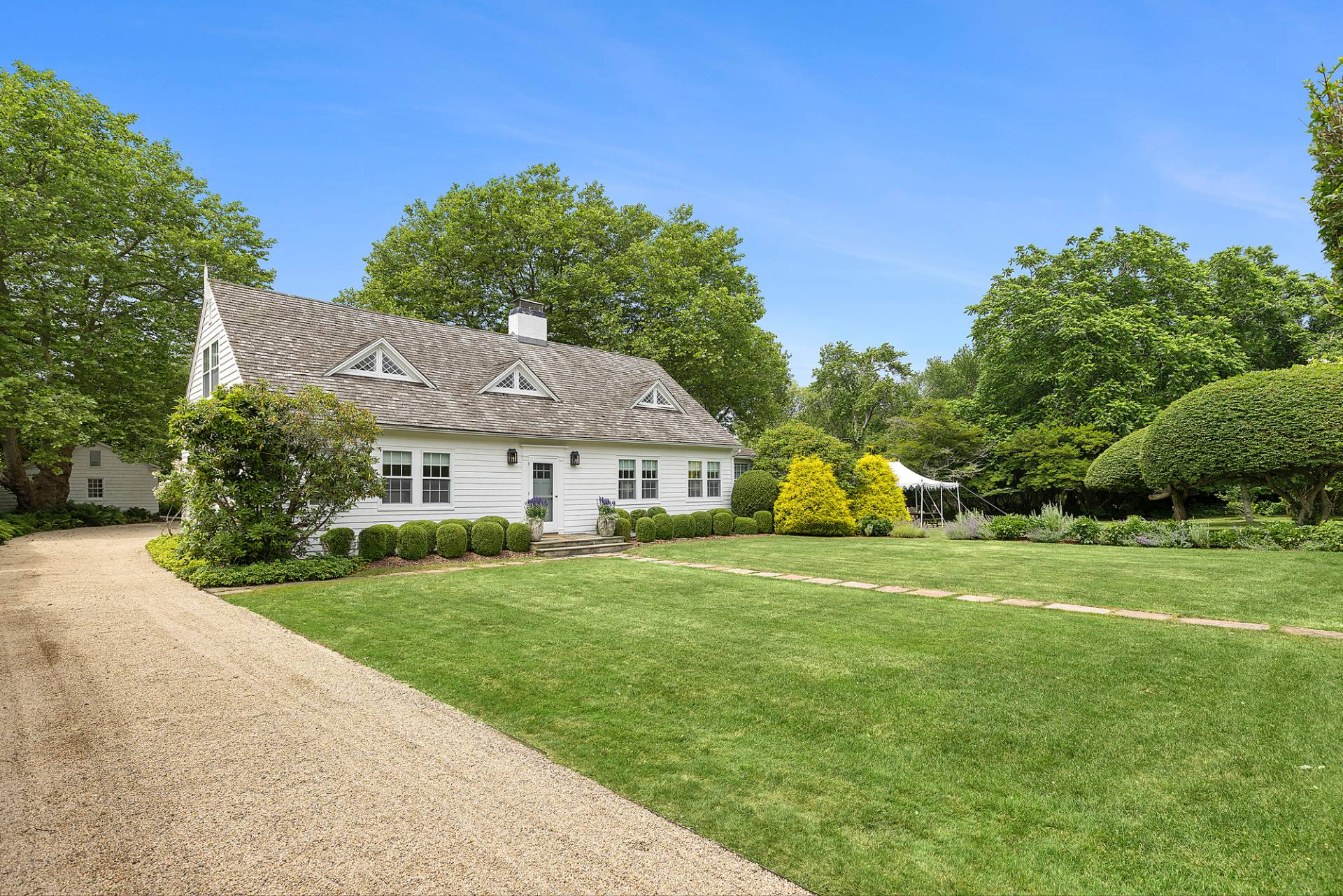 93 Egypt Lane East Hampton, NY 11937 - Photo 50 of 50 a front view of a house with a yard and garage