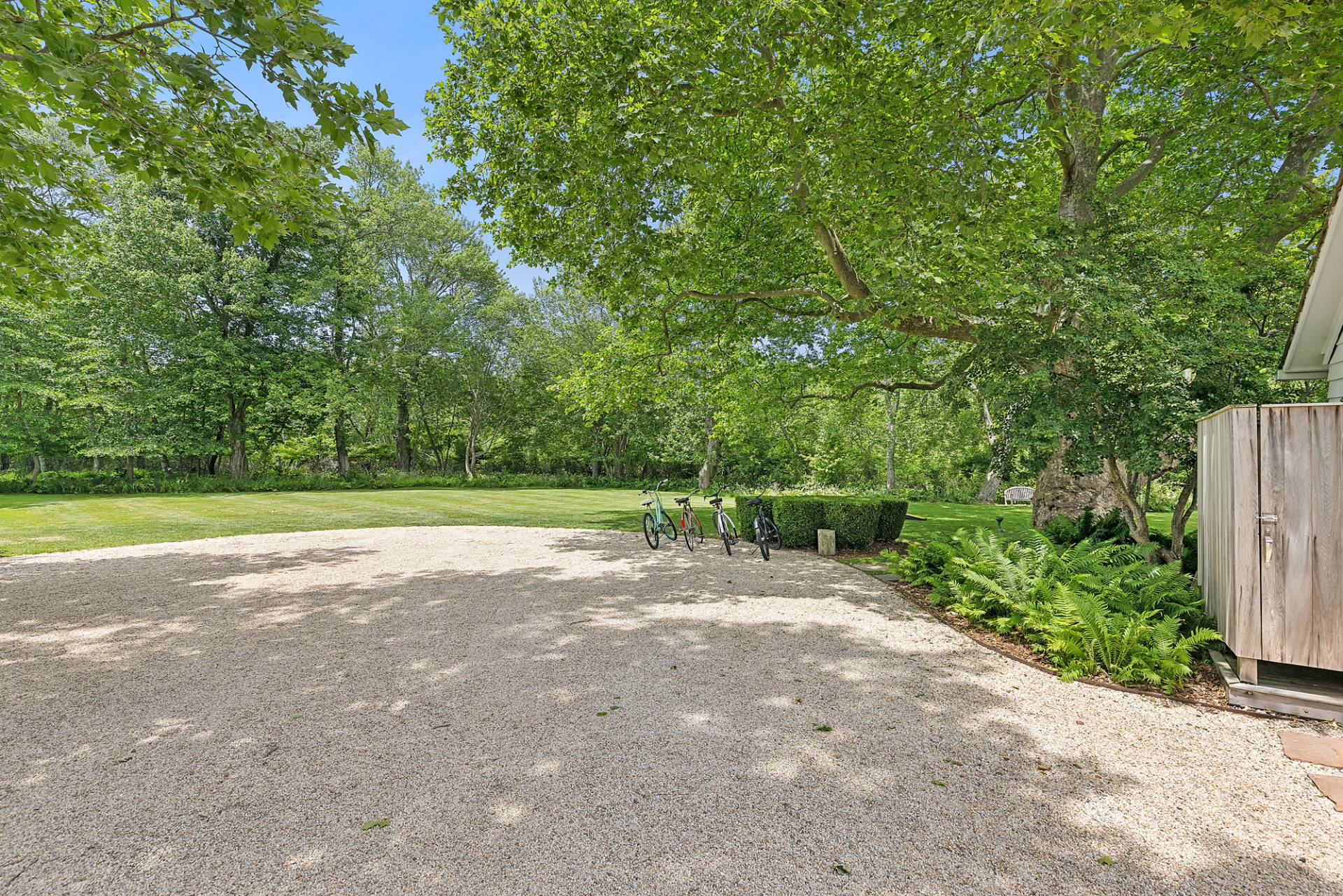 93 Egypt Lane East Hampton, NY 11937 - Photo 6 of 50 a view of a garden with a bench
