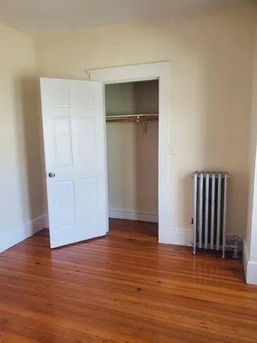 a view of a room with wooden floor and closet