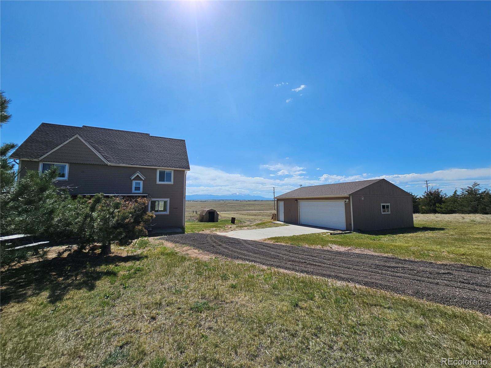 16985 Sage Crest Road Peyton, CO 80831 - Photo 2 of 25 a backyard of a house with wooden fence