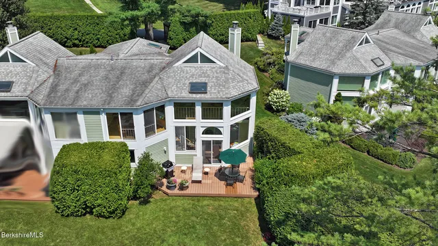 a front view of a house with a garden and plants