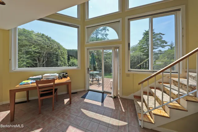 a outdoor room with wooden floor and windows