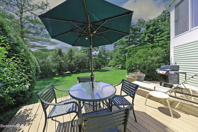 a view of a table and chairs under an umbrella