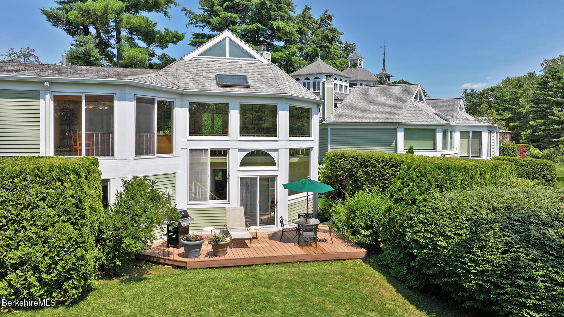 19 Hawthorne Road, Unit GH 4 Stockbridge, MA 01262 - Photo 23 of 46 a front view of a house with a yard table and chairs