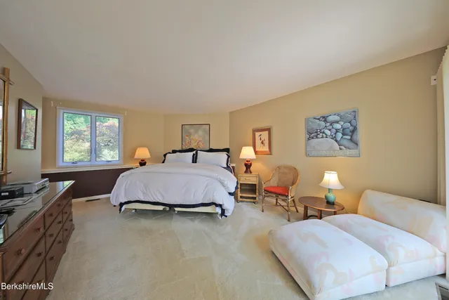 a spacious bedroom with a bed and window