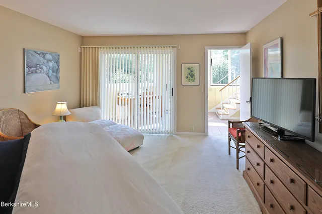 a bedroom with furniture and a flat screen tv