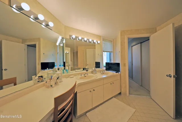 a spacious bathroom with a double vanity sink mirror and