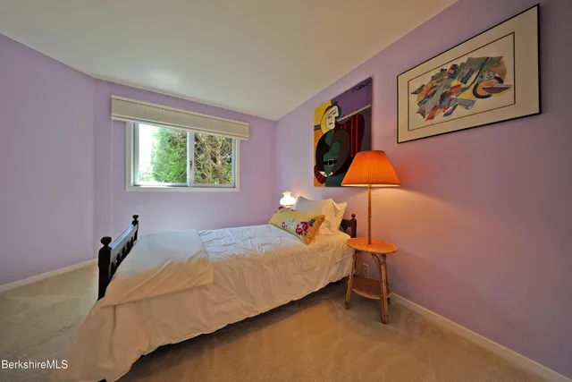 a bed room with a bed and a window