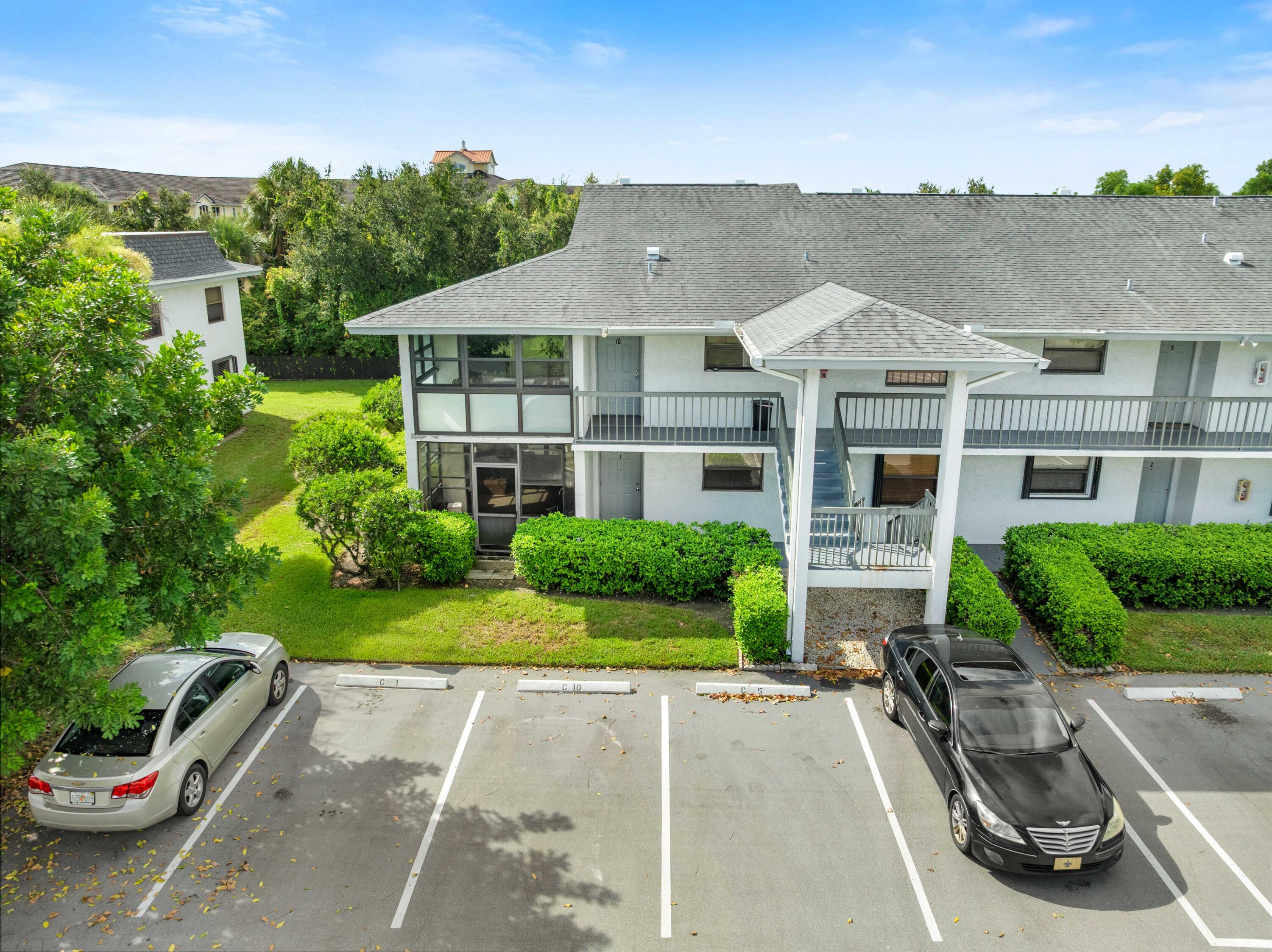 1250 Southeast Parkview Place, Unit C10 Stuart, FL 34994 - Photo 19 of 19 a front view of a house with a yard