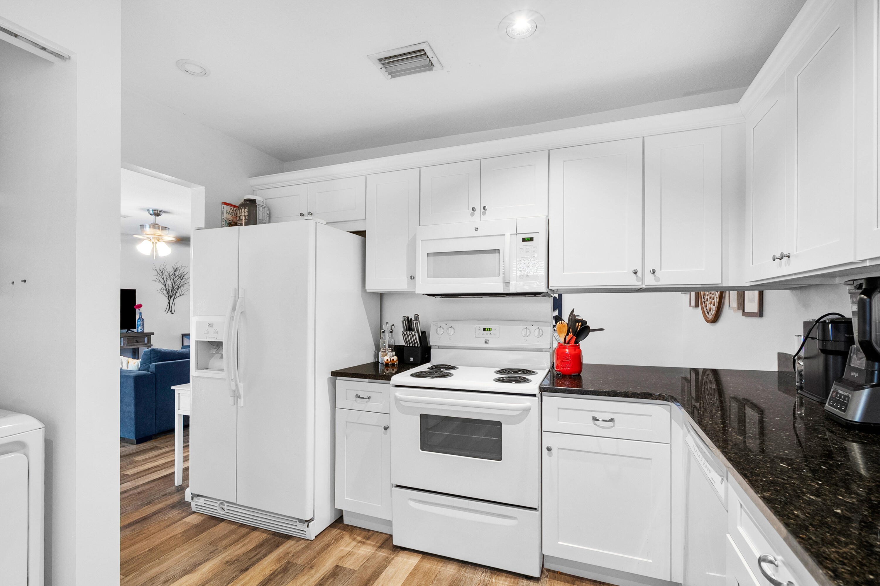 1250 Southeast Parkview Place, Unit C10 Stuart, FL 34994 - Photo 5 of 19 a white kitchen with sink and white stainless steel appliances