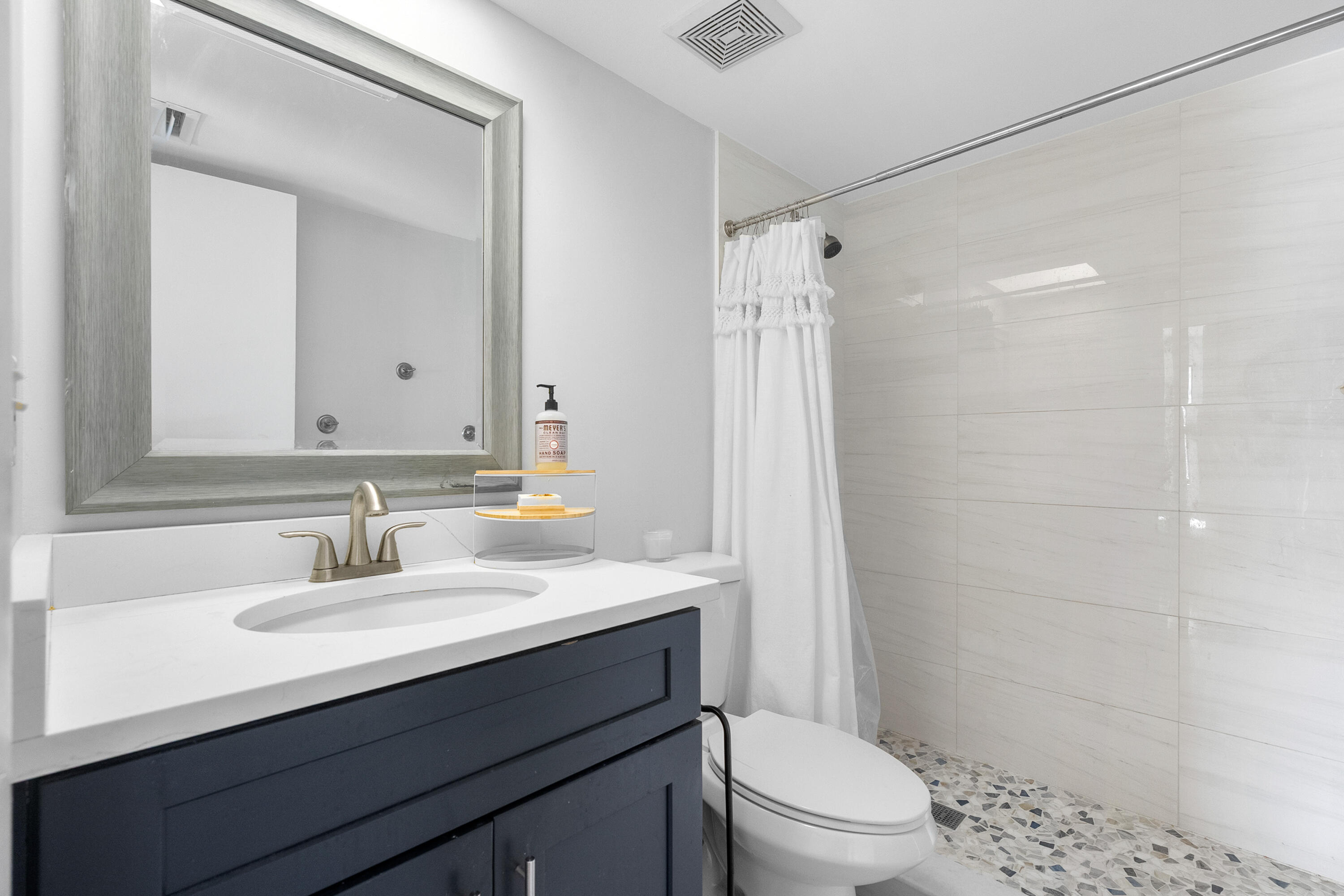 1250 Southeast Parkview Place, Unit C10 Stuart, FL 34994 - Photo 9 of 19 a bathroom with a sink a toilet a mirror and shower