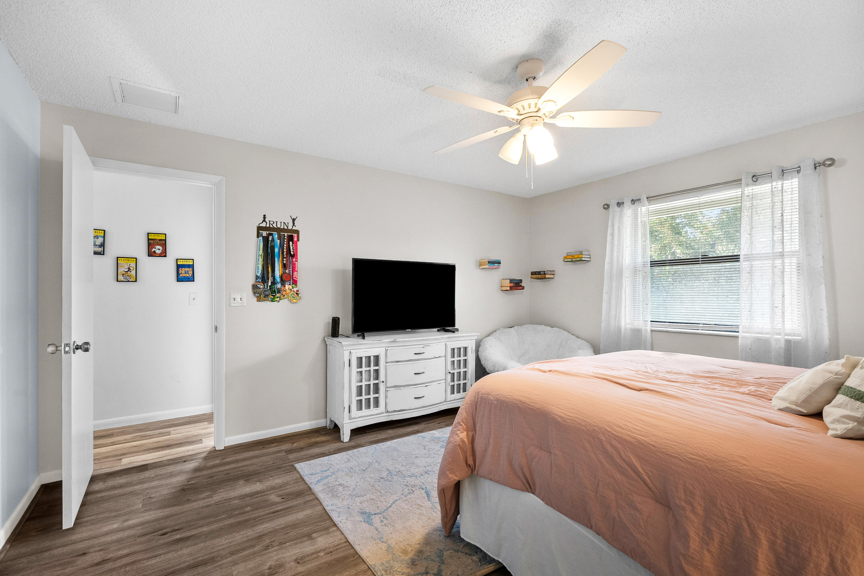 1250 Southeast Parkview Place, Unit C10 Stuart, FL 34994 - Photo 10 of 19 a bedroom with a bed and a flat screen tv