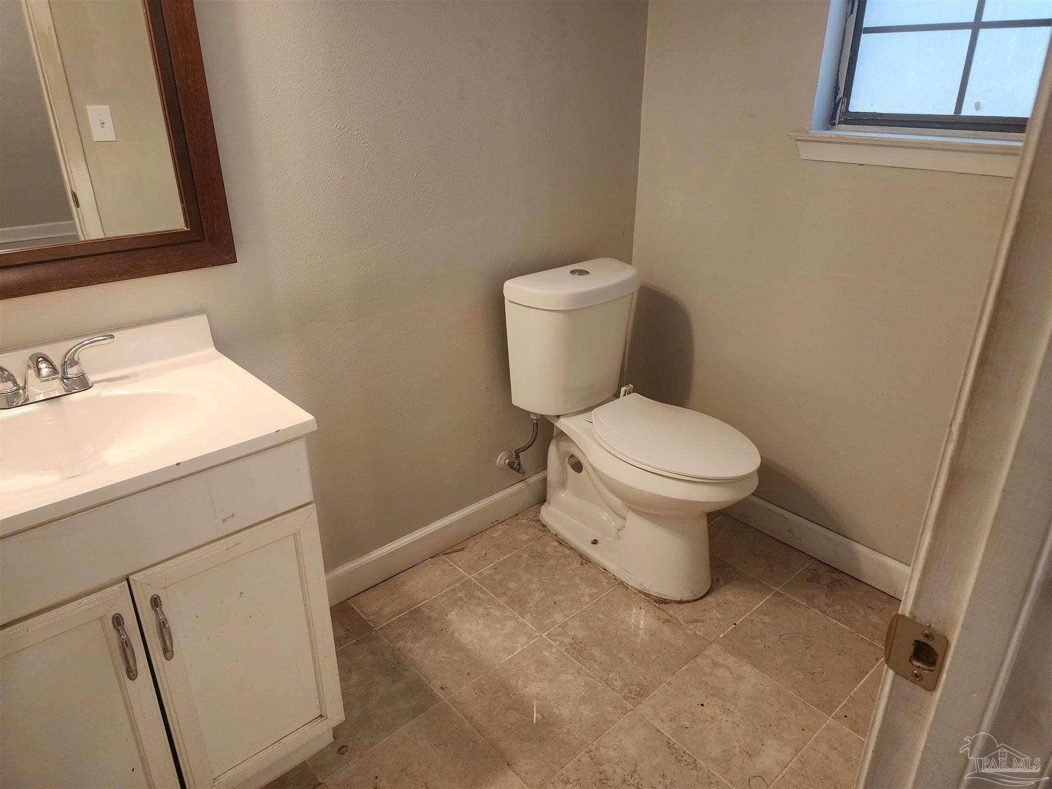 4839 Lynn Drive Pace, FL 32571 - Photo 19 of 24 a white toilet sitting next to a bathroom sink