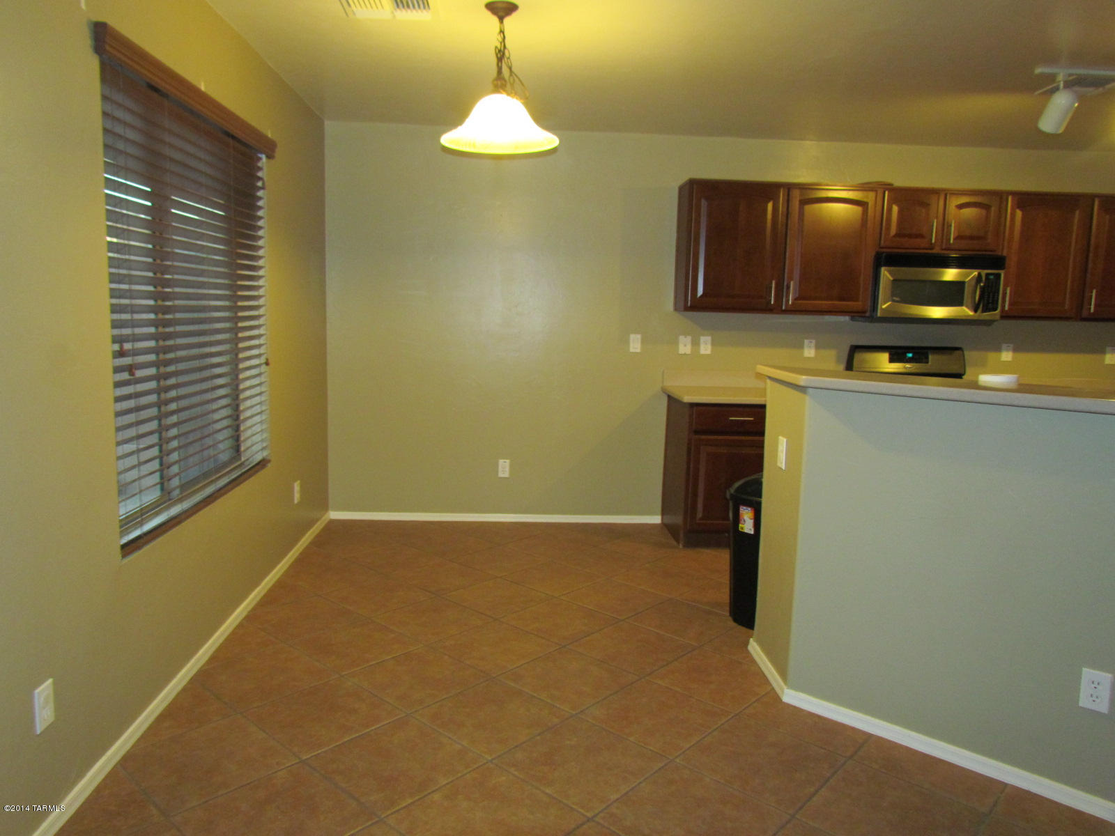 669 West Ash Ridge Drive Green Valley, AZ 85614 - Photo 5 of 17 a view of a kitchen with furniture and a flat screen tv