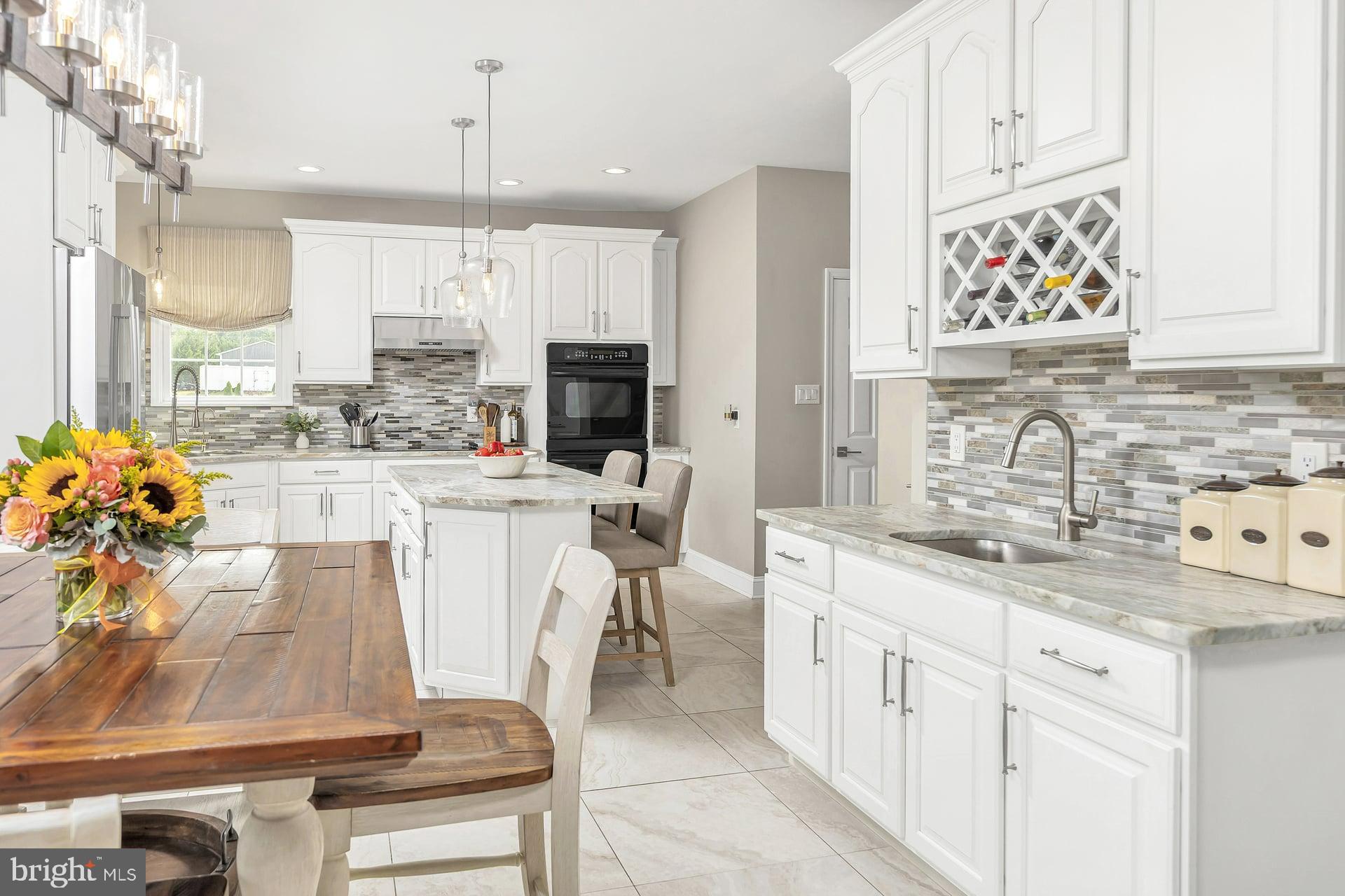 221 Point Airy Road Pilesgrove, NJ 08098 - Photo 11 of 34 a kitchen with a sink stove and cabinets
