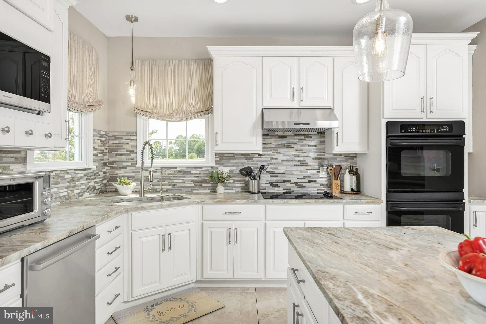 221 Point Airy Road Pilesgrove, NJ 08098 - Photo 13 of 34 a kitchen with stainless steel appliances granite countertop a stove and cabinets