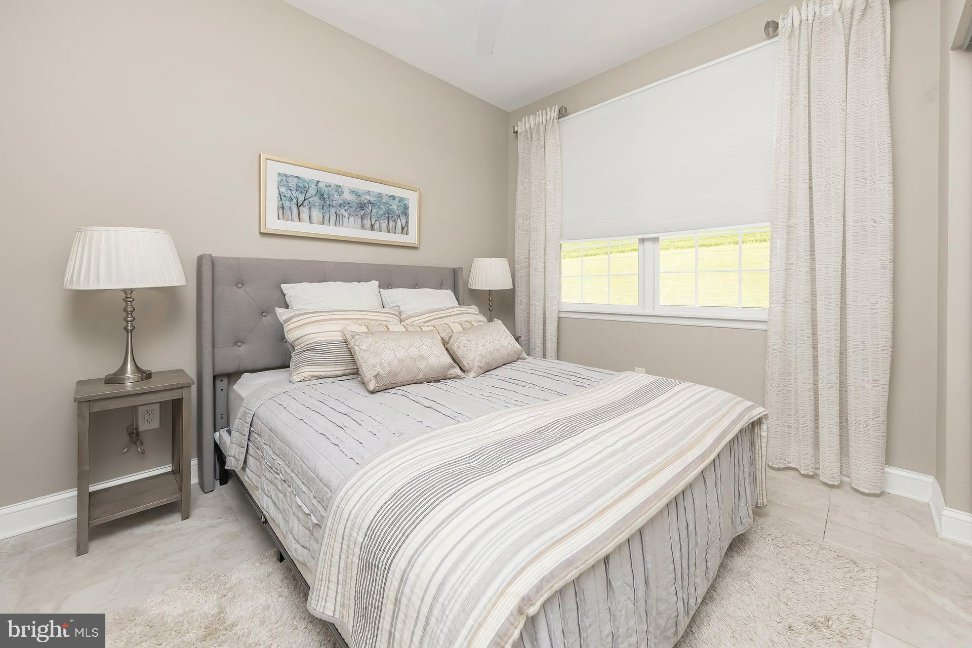 221 Point Airy Road Pilesgrove, NJ 08098 - Photo 20 of 34 a bedroom with a bed and a lamp