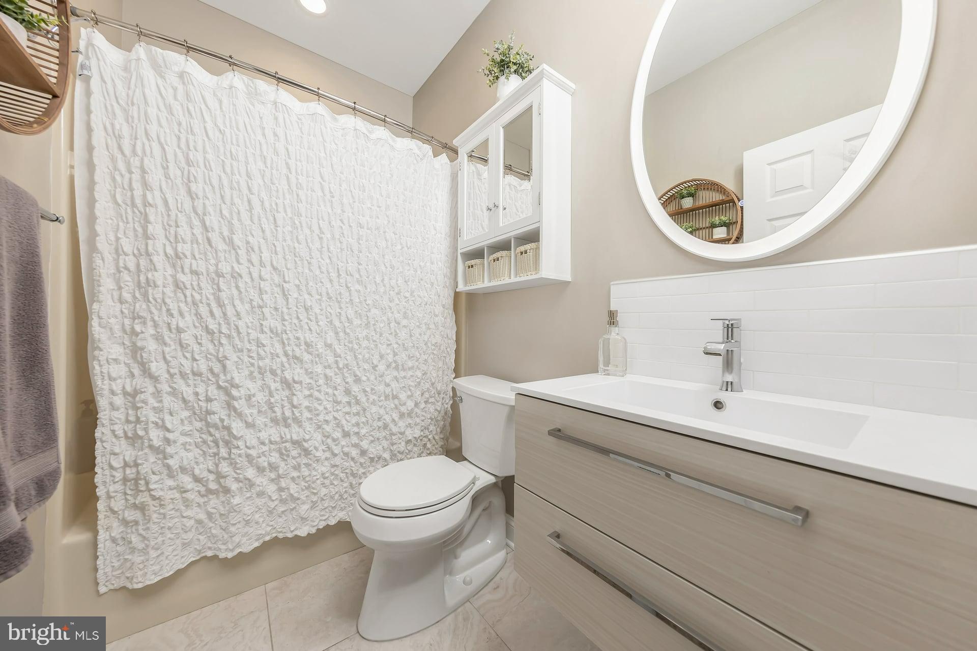 221 Point Airy Road Pilesgrove, NJ 08098 - Photo 21 of 34 a bathroom with a toilet sink vanity and mirror