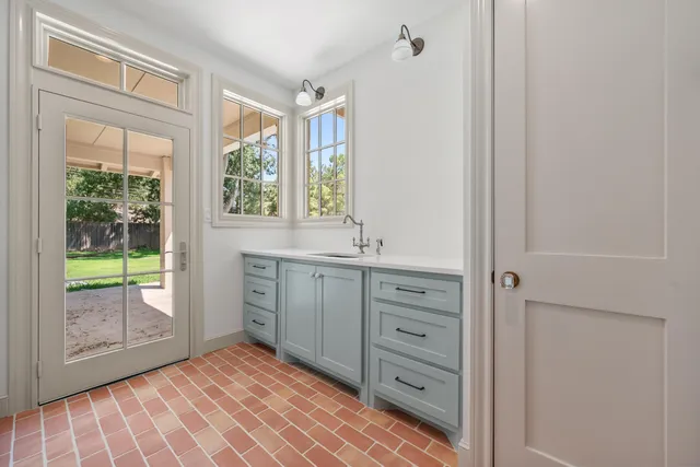 a bathroom with a sink mirror and window