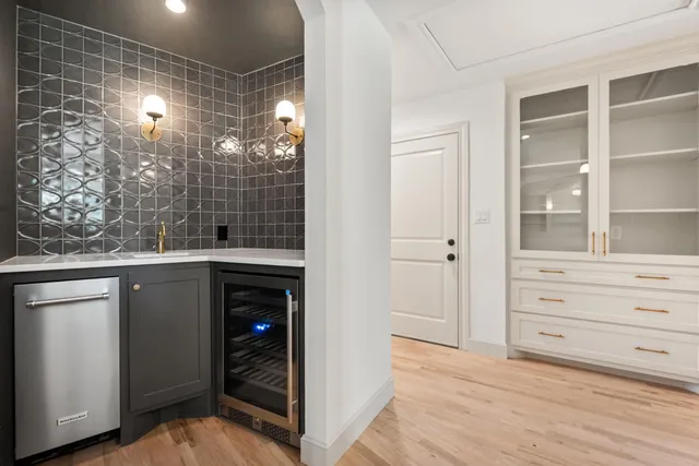 a view of an empty room with cabinet and a window