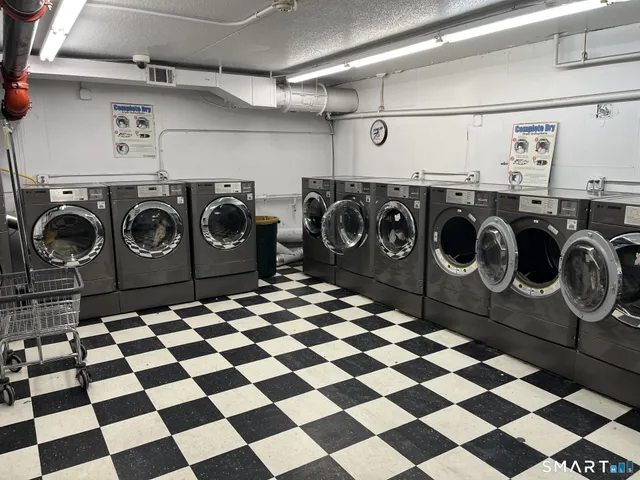 a utility room with a black white checkered floor