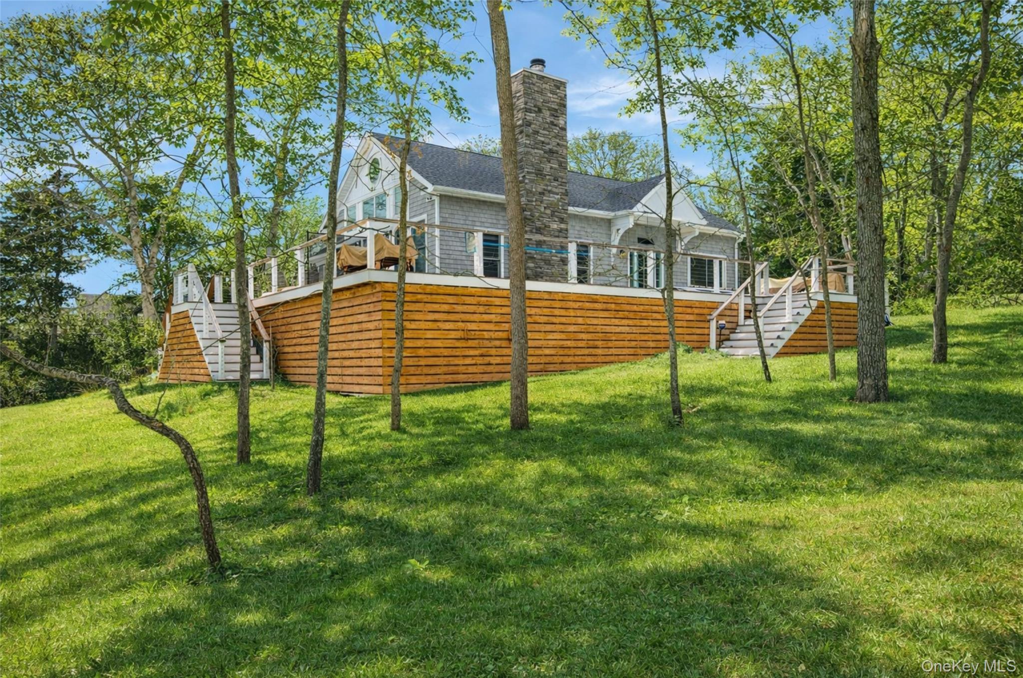80 Louse Point Road East Hampton, NY 11937 - Photo 1 of 19 a view of a house with a backyard