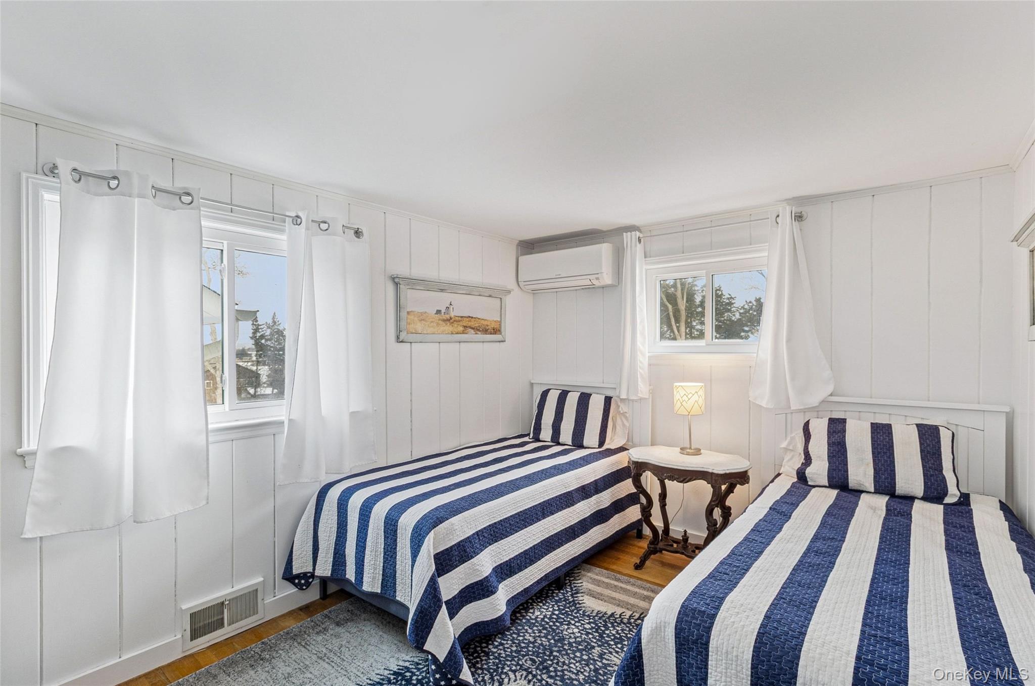80 Louse Point Road East Hampton, NY 11937 - Photo 11 of 19 a bedroom with a bed and a window