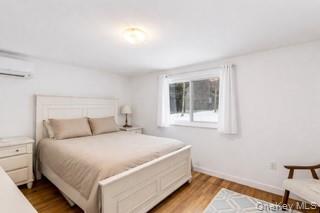 80 Louse Point Road East Hampton, NY 11937 - Photo 12 of 19 a bedroom with a bed and window