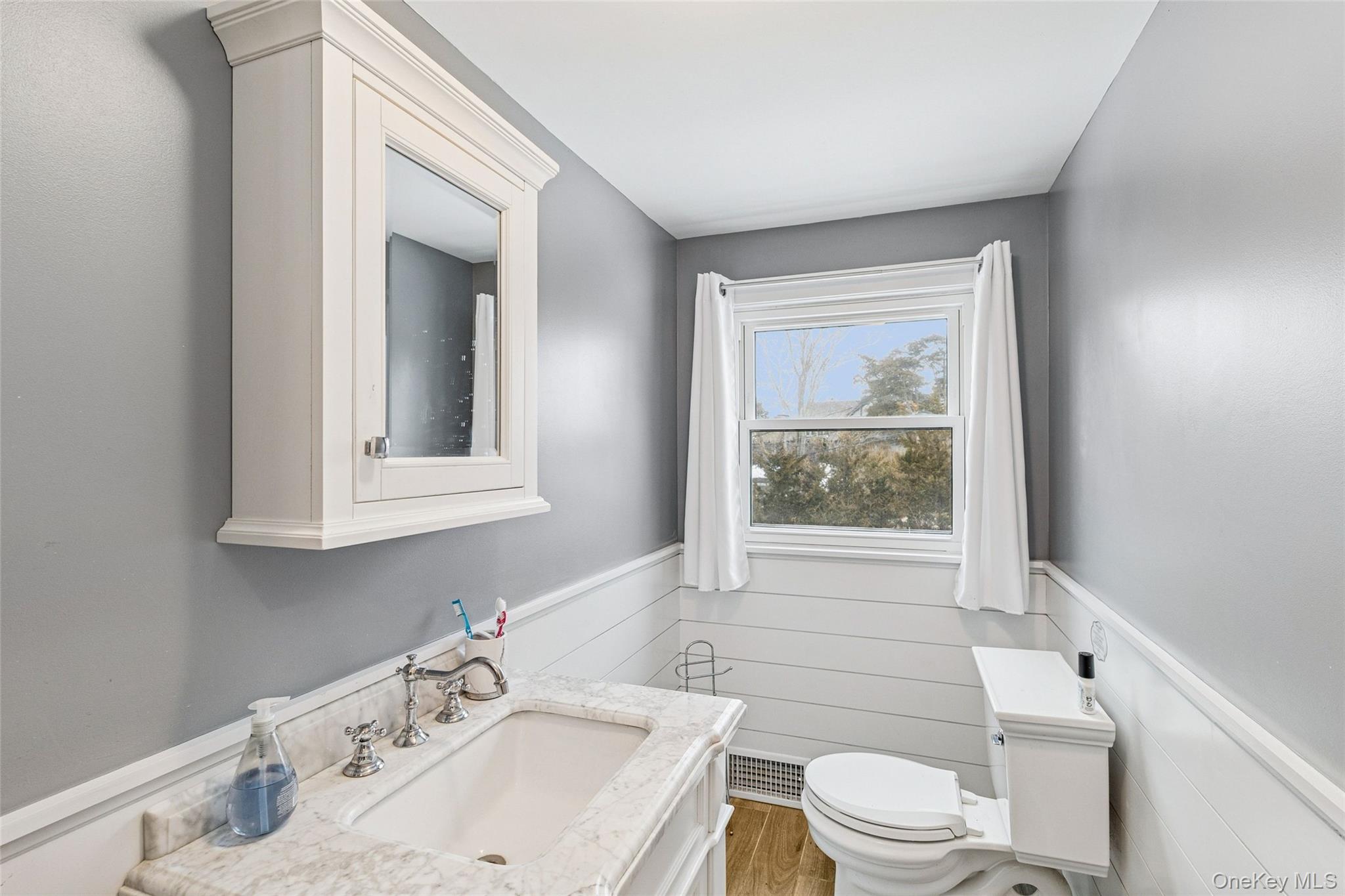 80 Louse Point Road East Hampton, NY 11937 - Photo 14 of 19 a bathroom with a sink toilet and tub