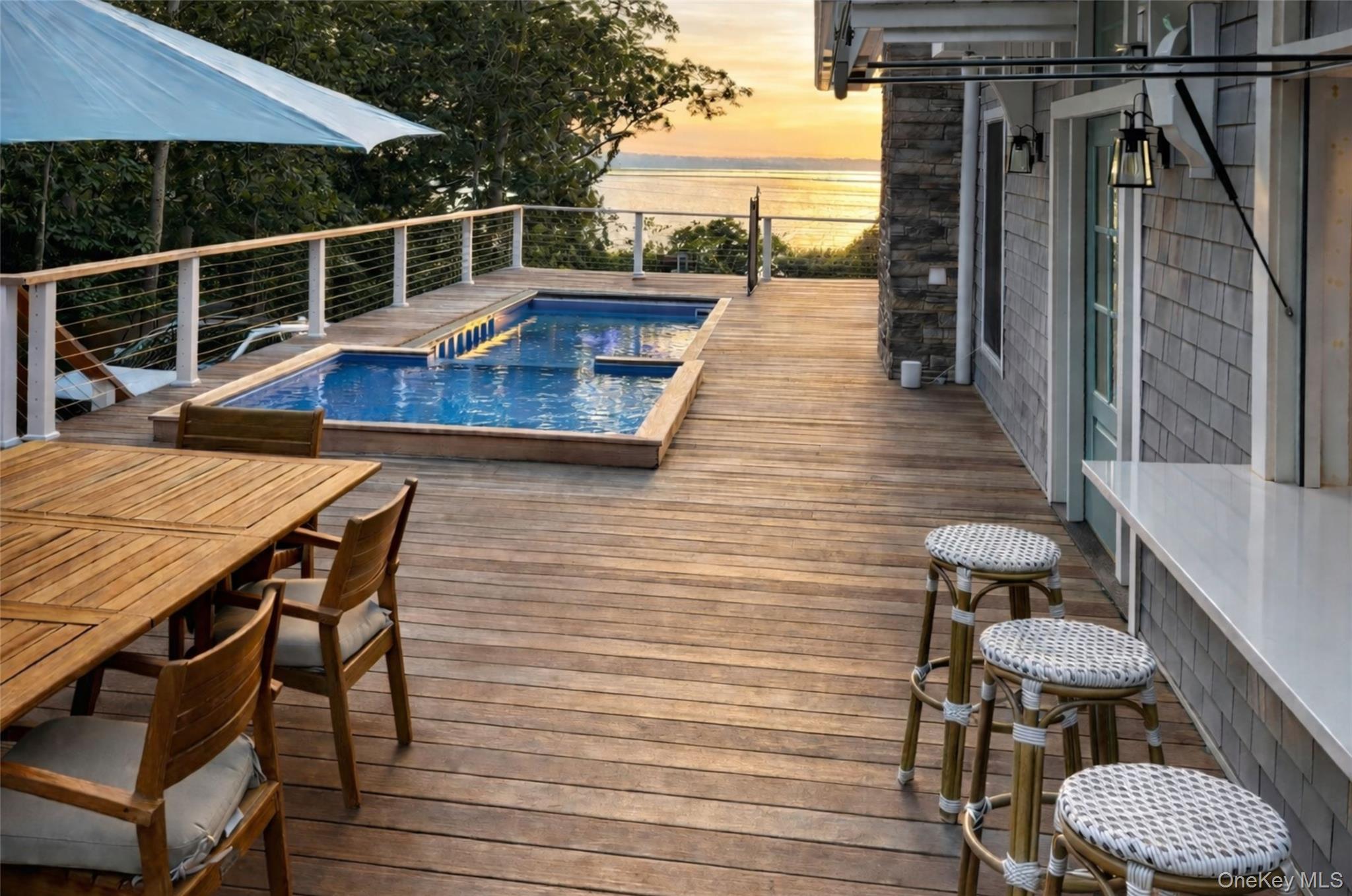 80 Louse Point Road East Hampton, NY 11937 - Photo 17 of 19 a view of deck with chair and wooden floor