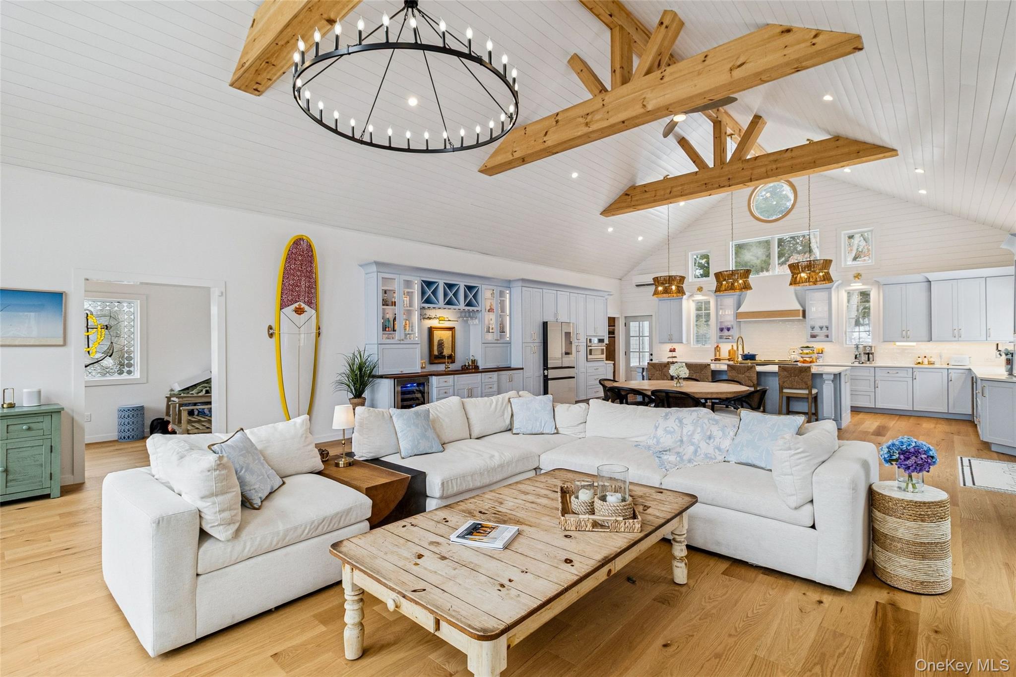 80 Louse Point Road East Hampton, NY 11937 - Photo 2 of 19 a living room with furniture a rug and a chandelier