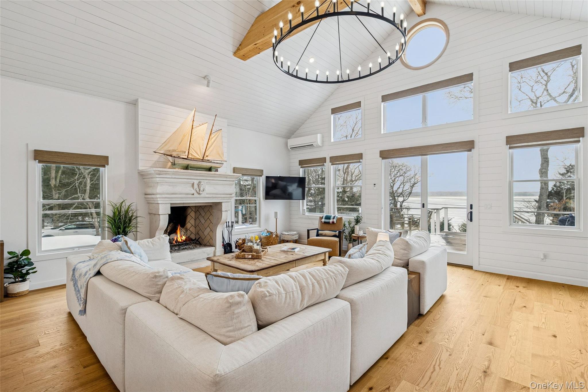 80 Louse Point Road East Hampton, NY 11937 - Photo 4 of 19 a living room with furniture a fireplace and a large window
