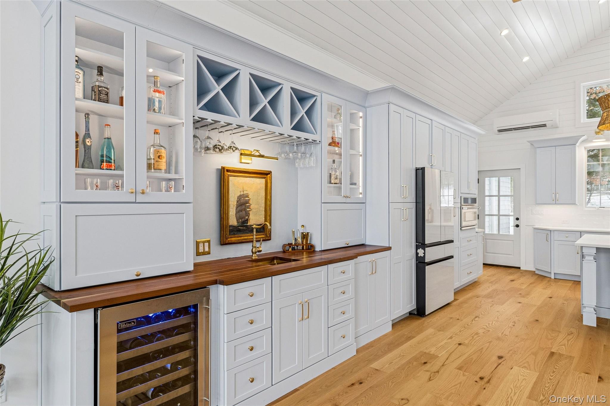 80 Louse Point Road East Hampton, NY 11937 - Photo 9 of 19 a hall with kitchen island white cabinets and stainless steel appliances