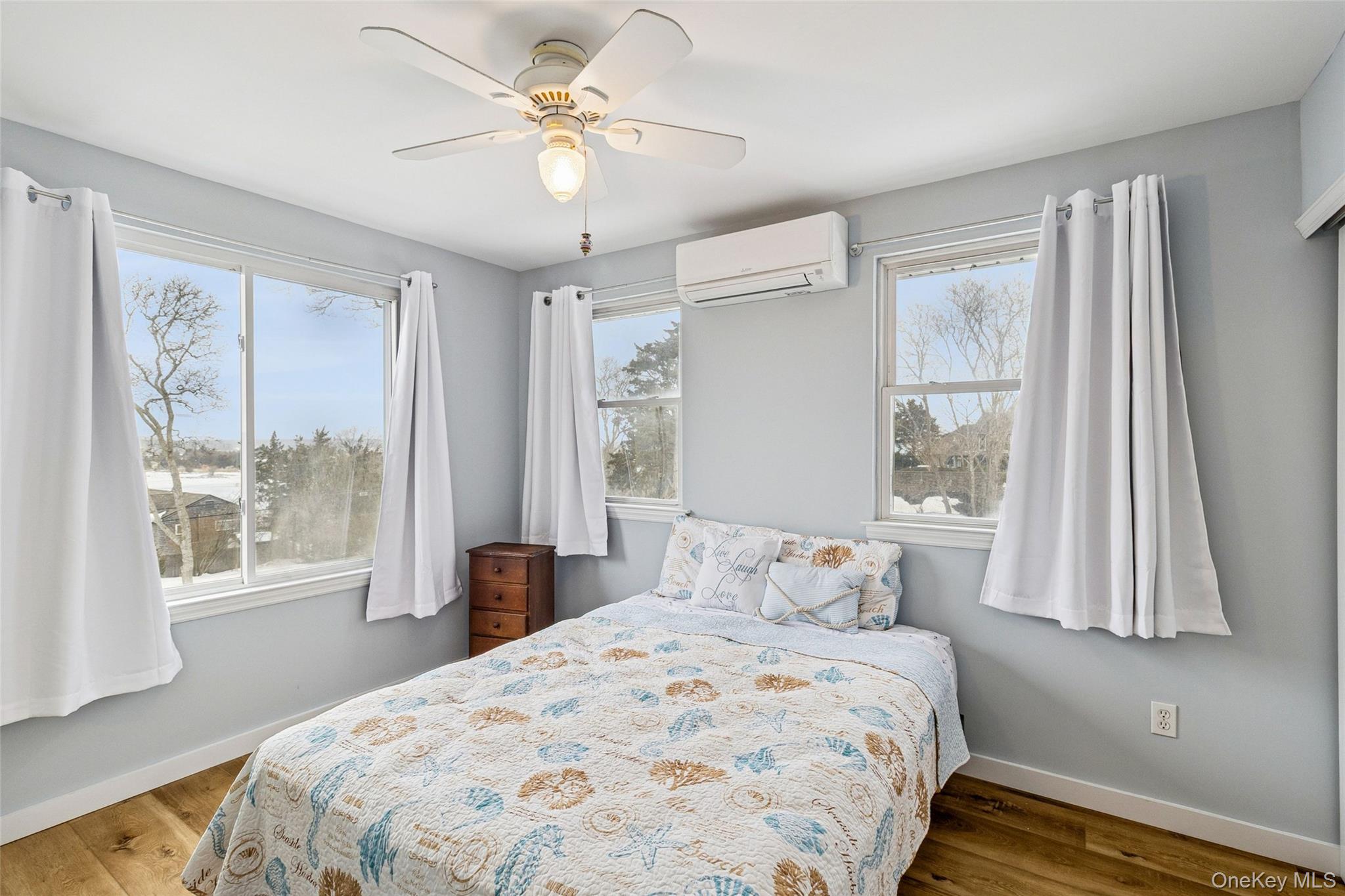 80 Louse Point Road East Hampton, NY 11937 - Photo 10 of 19 a bedroom with a large bed and a window