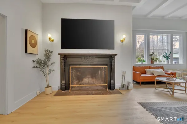 a living room with furniture a flat screen tv and a fireplace