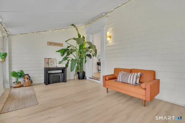 a living room with furniture and a potted plant