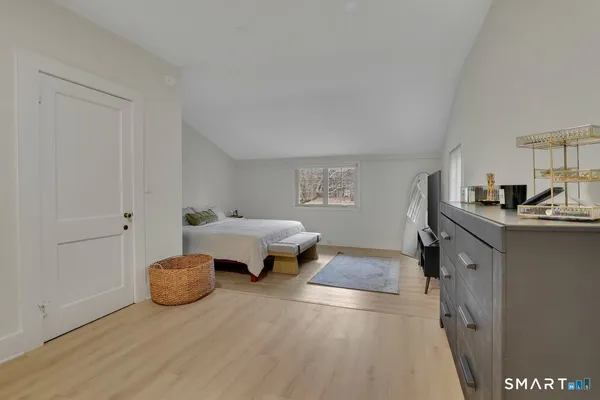 a bedroom with furniture and a window