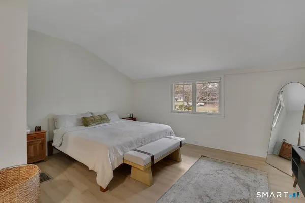 a spacious bedroom with a bed and a couch