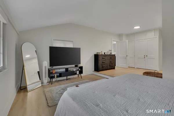 a bedroom with furniture and a flat screen tv