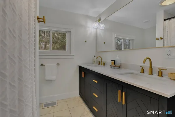 a bathroom with a sink double vanity and a mirror