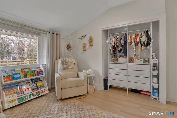 a living room with furniture and a baby crib