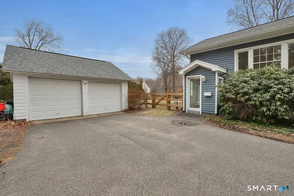 a view of a house with a yard and garage