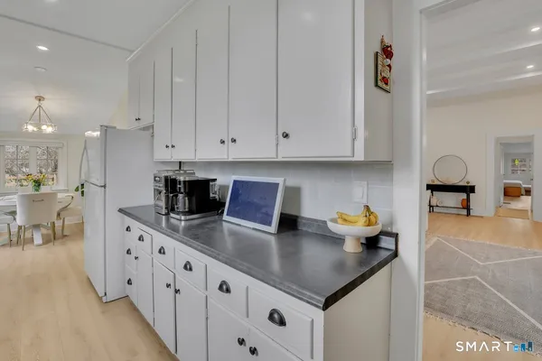 a kitchen with stainless steel appliances granite countertop a sink dishwasher and cabinets with wooden floor